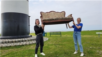 Zwei starke Frauen. Das neue alte Kultursofa der Gemeinde Wurster Nordseeküste stemmen Saskia Stöwing (links) und Ulla Puckhaber mit links.